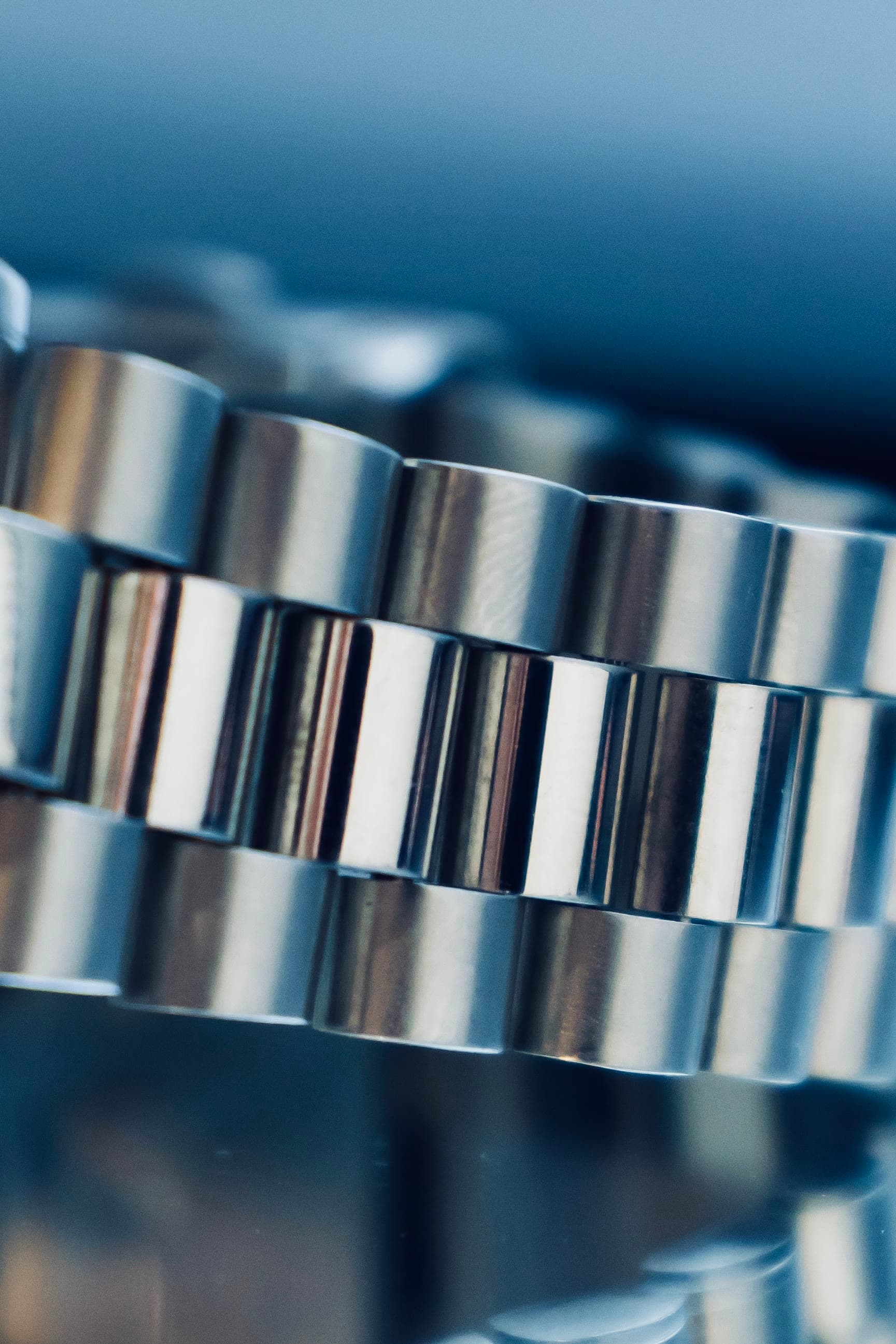 The steel bracelet of an AWI watch with an engraved logo, macro