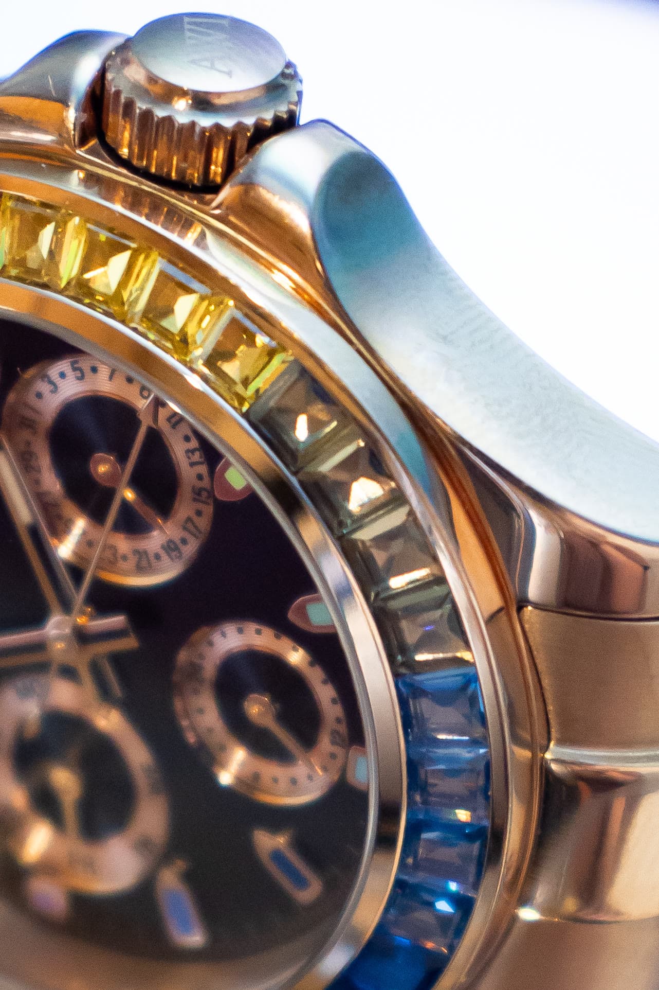 The crown and rainbow bezel of an AWI watch, macro