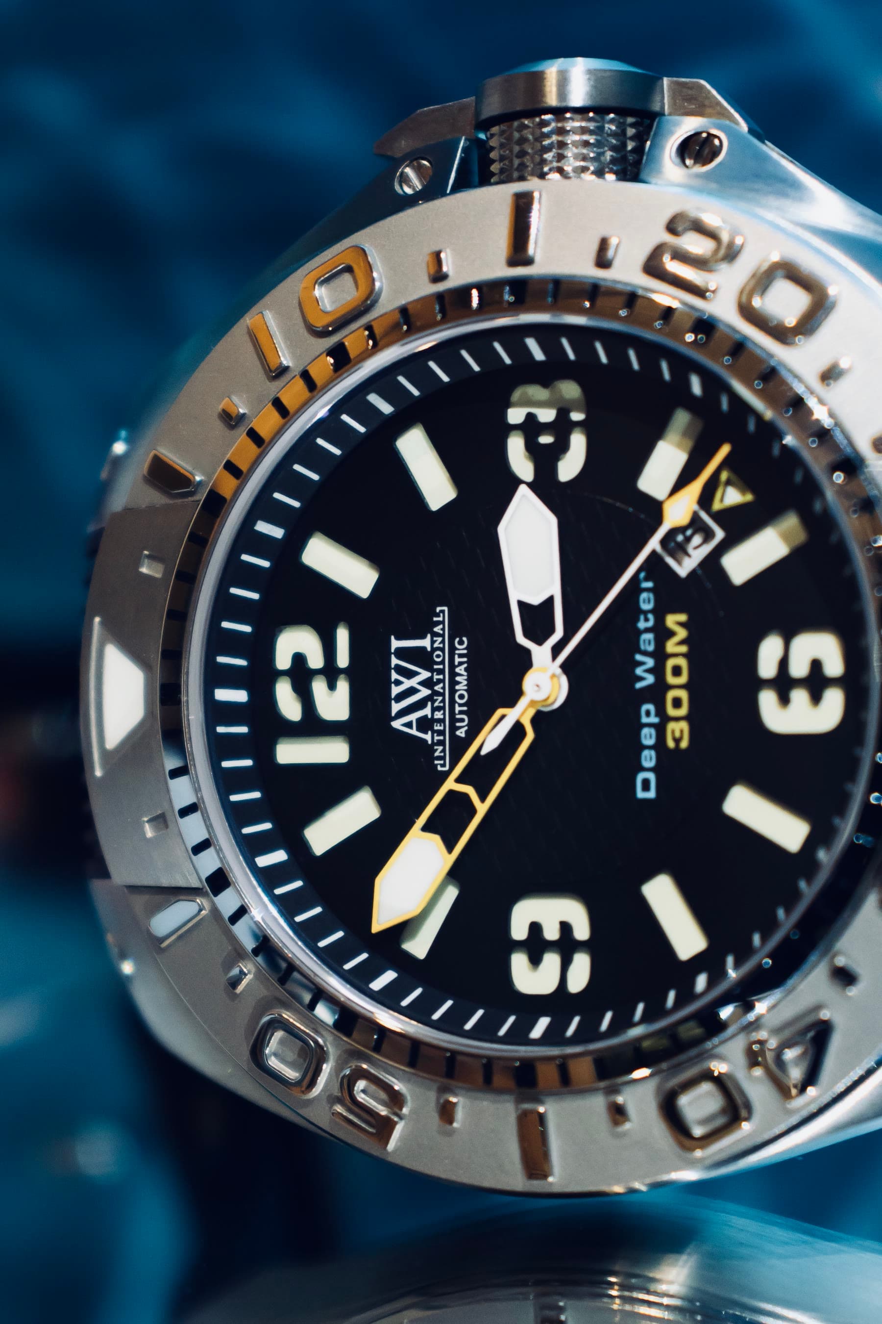 The AWI Deep Water 300M diver's watch, a close-up of the black dial