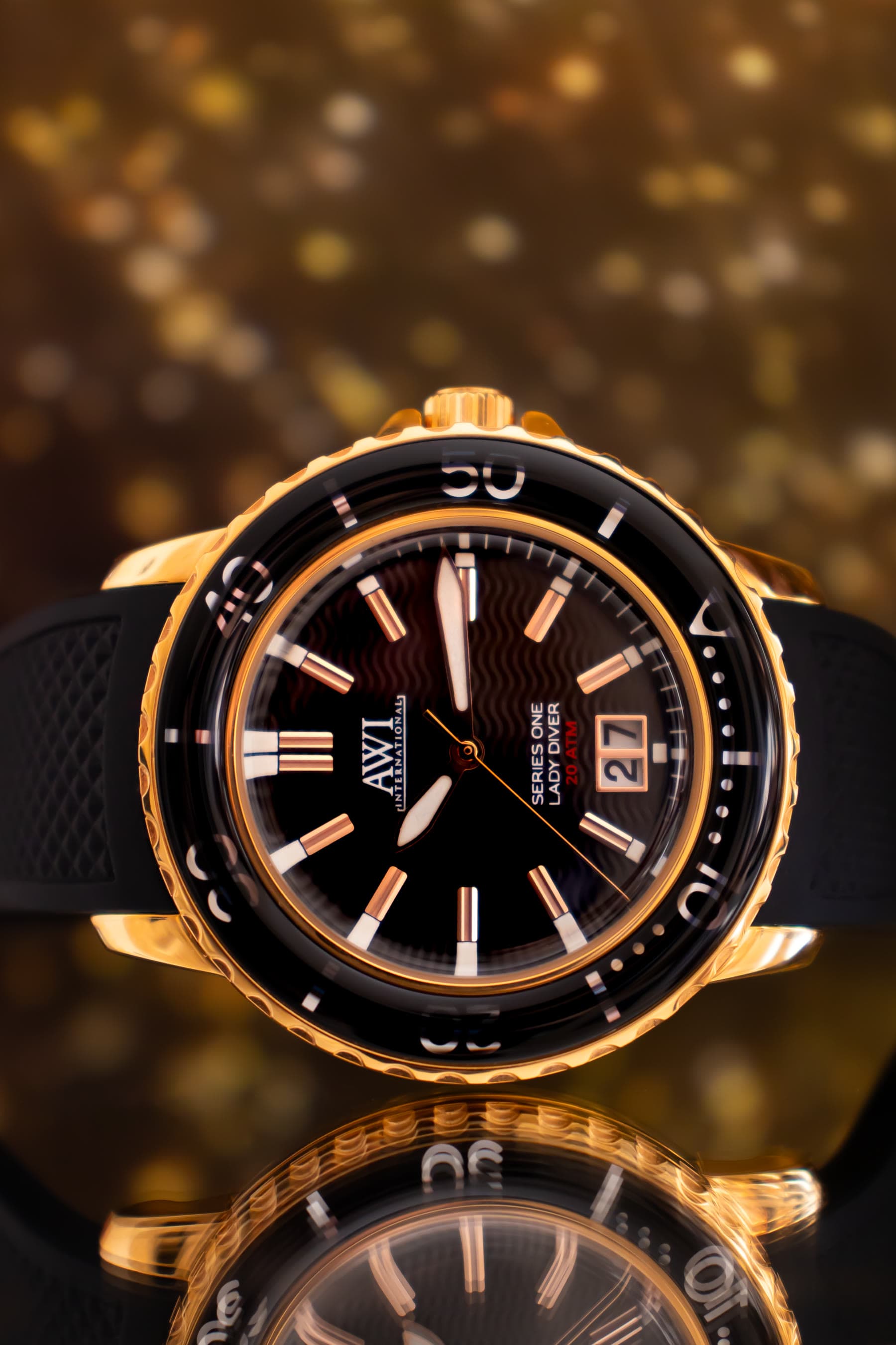 A gold AWI watch against warm bokeh