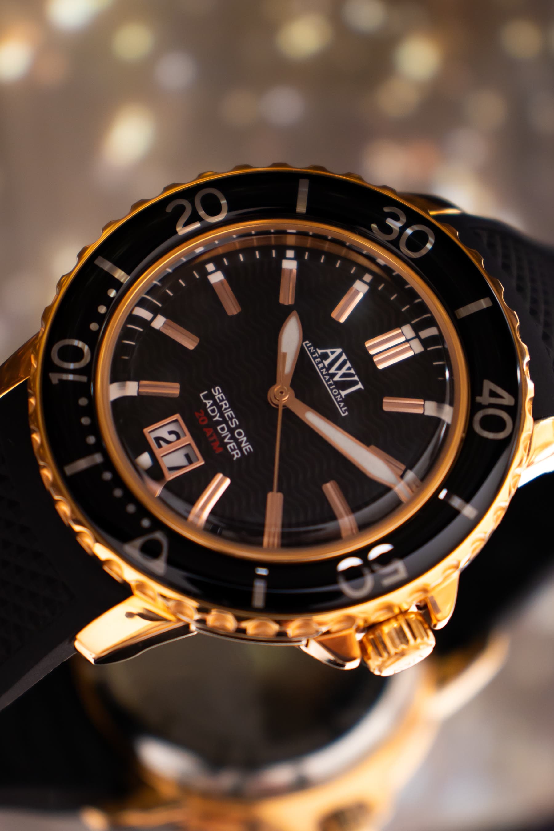 A gold AWI diver's watch with a black dial