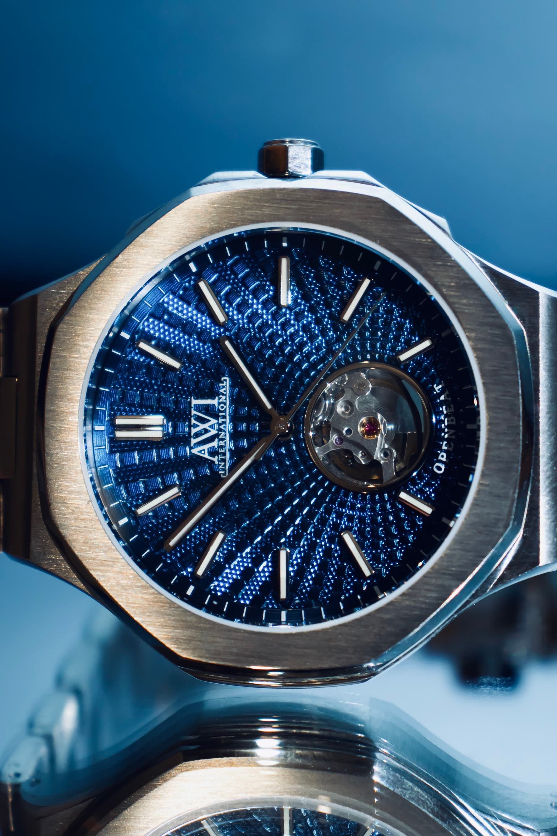 An AWI watch with a blue guilloché dial and an open balance wheel