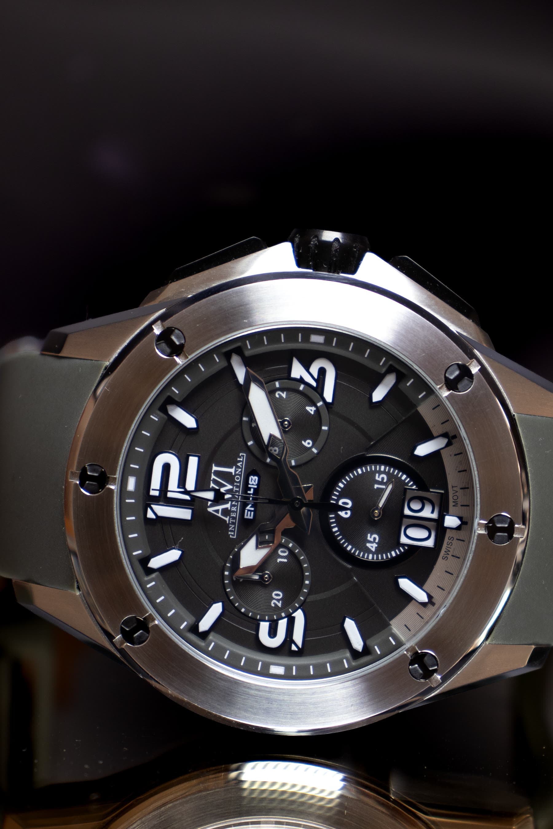 An AWI watch in a tonneau case with a light dial