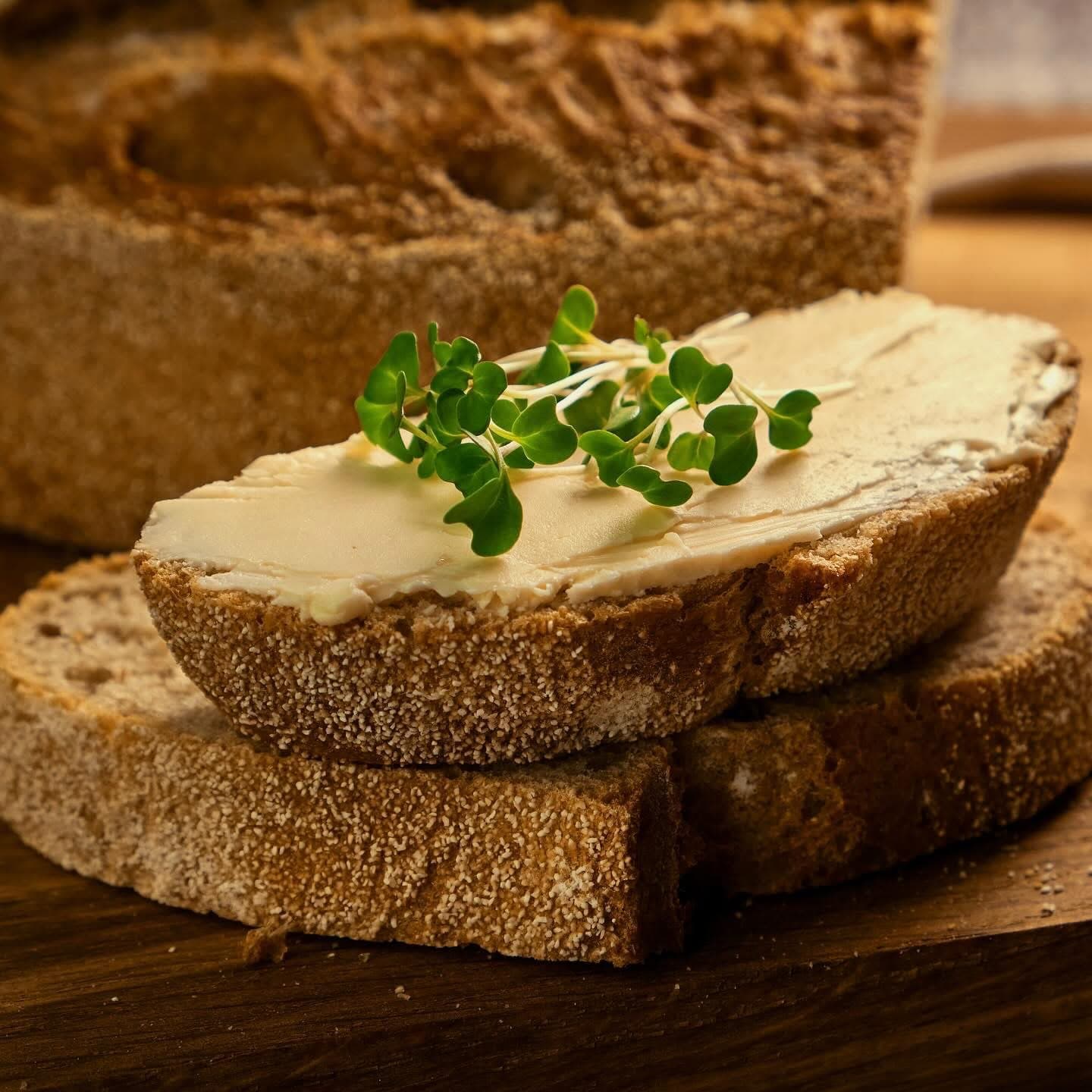 Toast with hummus and microgreens on a wooden board