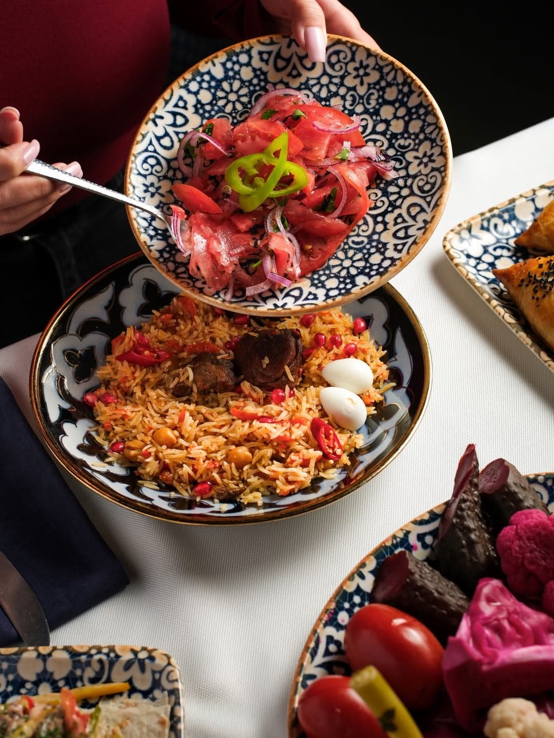 Plov and a marinated beef salad in Uzbek ceramics